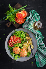 Italian pasta. Farfalle with meatballs and salad on dark background. Dinner. Top view, overhead. Slow food concept