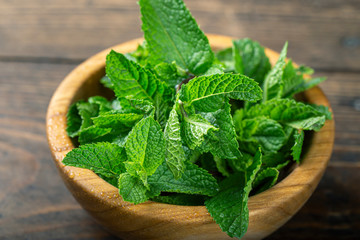 Green fresh mint on the wooden table.