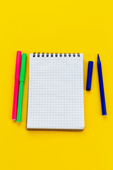 School supplies. Notepad and markers on a white background.