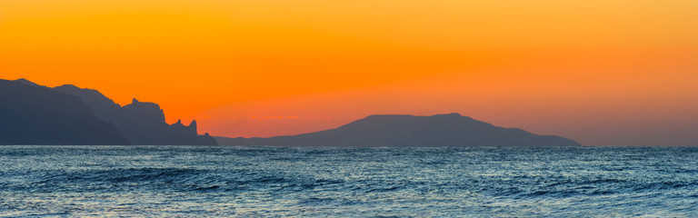 sea bay with rocky coast at the sunrise, wide outdoor dawn natural background