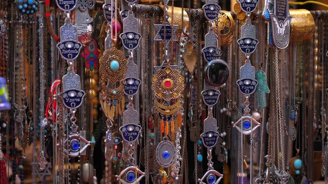 Hamsa good luck palm shaped charms, moving slightly with the wind.