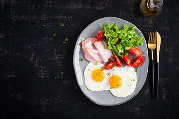Ketogenic/paleo diet. Fried eggs, ham and fresh salad.  Keto breakfast. Brunch.  Top view, overhead