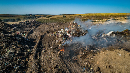 burning dump with white smoke shot from drone