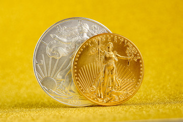 silver eagle and golden american eagle one ounce coins.