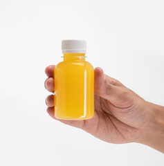 hand holding fruit juice on a plastic bottle product mockup