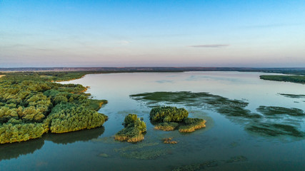 green islands of trees on lake beleu, moldova
