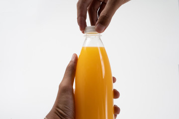 hand holding fruit juice on a plastic bottle product mockup