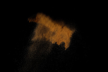 Sandy explosion isolated on black background. Abstract sand cloud.