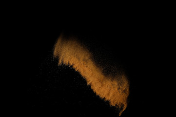 Sandy explosion isolated on black background. Abstract sand cloud.