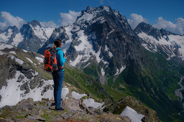 Fototapeta na wymiar Woman hiker on a top of a mountain