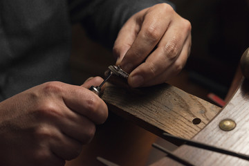 Working desk for craft jewelery making with professional tools. Master of jewelry manually...