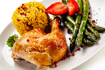 Deep fried chicken drumsticks with rice and asparagus on white background
