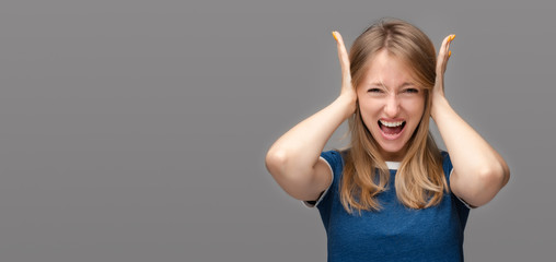 Plakat Angry Blonde girl shut ears with hands and screaming. Copy space