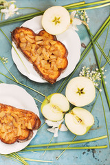 Group of slices of apples and sandwiches with apples on table