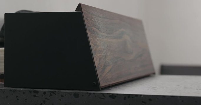 Slow motion man hand check walnut wood breadbox