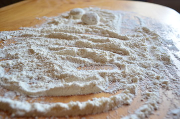 making homemade dumplings with your hands. The table is in flour.