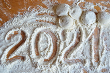 making homemade dumplings with your hands. The table is in flour.