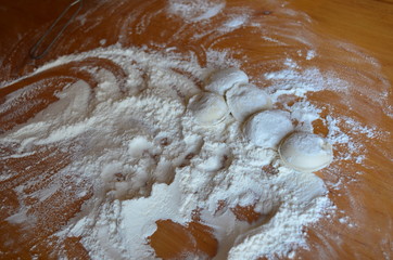 making homemade dumplings with your hands. The table is in flour.
