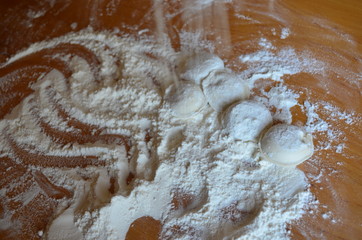 making homemade dumplings with your hands. The table is in flour.