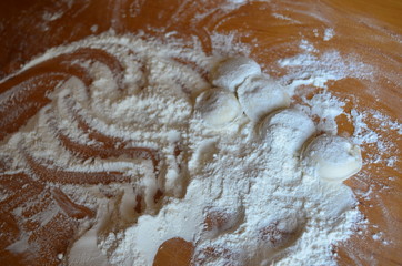 making homemade dumplings with your hands. The table is in flour.
