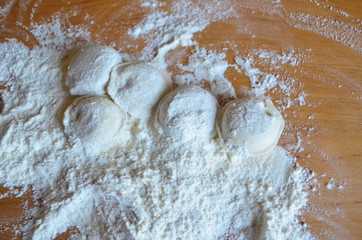 making homemade dumplings with your hands. The table is in flour.