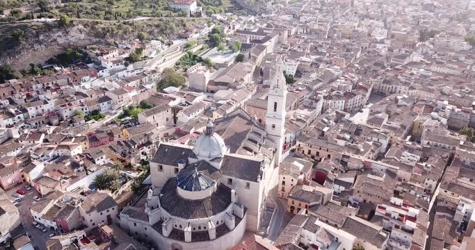 View from drone of Roman Catholic Basilica in Spanish town of Xativa on background of residential areas 
