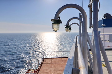 Ship structures, masts, antennas, funnel, ship wheelhouse against the blue sky and clouds. Vessel traveling at ocean. © masterskuz55