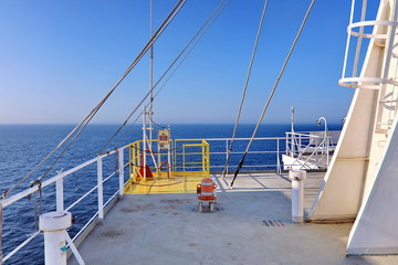Ship structures, masts, antennas, funnel, ship wheelhouse against the blue sky and clouds. Vessel traveling at ocean. © masterskuz55