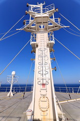 Ship structures, masts, antennas, funnel, ship wheelhouse against the blue sky and clouds. Vessel...