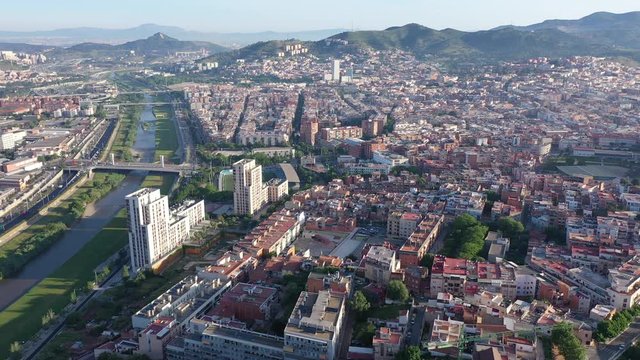 Aerial view of Santa Coloma de Gramenet with a apartment buildings and Besos river, Spain. High quality 4k footage