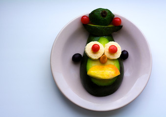 Children's food, vegetable salad in the form of an aboriginal woman's face, funny face.