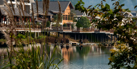 The sunrise scenery of Xibu Street in Zhangjiajie, Hunan province is composed of stilted buildings, ancient buildings, streets, rivers, orange sky and reflection as the background, and quiet effect. C