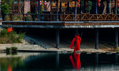 Obraz na płótnie Canvas The sunrise scenery of Xibu Street in Zhangjiajie, Hunan province is composed of stilted buildings, ancient buildings, streets, rivers, orange sky and reflection as the background, and quiet effect. C