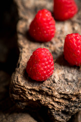 Ripe raspberry on the wooden plank. Selective focus. Shallow depth of field.