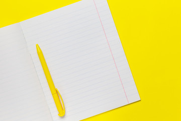September first, the beginning of the school year, stationery for study, school and office supplies open notebook sheet in a line, pen, form for writing text on a bright yellow background