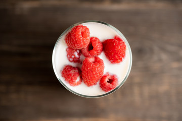 Milk with raspberry in the glass. Selective focus. Shallow depth of field.