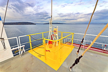 Ship structures, masts, antennas, funnel, ship wheelhouse against the blue sky and clouds. Vessel traveling at ocean. © masterskuz55