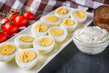 boiled chicken eggs on a dark stone background