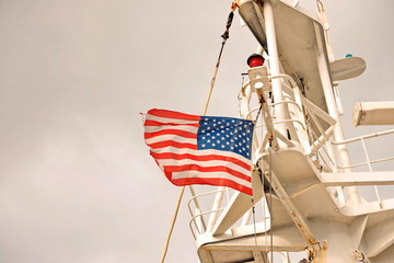 Ship structures, masts, antennas, funnel, ship wheelhouse against the blue sky and clouds. Vessel traveling at ocean. © masterskuz55