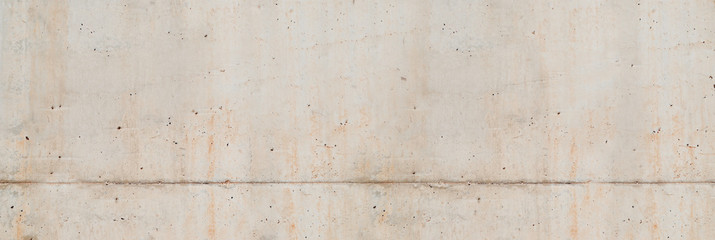 Concrete wall. Weathered old paints on the spilled wall.