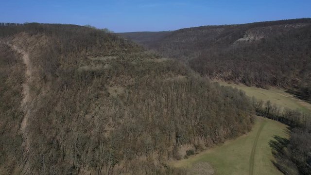 Spring flight through valley towards ruins of Cabrad castle, central Slovakia
