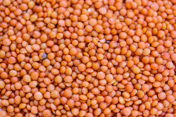 Red lentils close-up. Background with lots of organic groats.