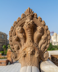 Fototapeta premium Hindu statue of snakes, One of the Indonesian statues studding the external terrace of historical palace of Baron Empain, Cairo, Egypt
