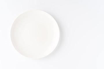 Fototapeta premium Empty white plate isolated on white background. Top view