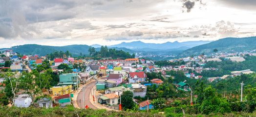 Naklejka premium Small village in a tea hill valley on afternoon in the highlands of Da Lat, Vietnam. The place provides a great deal of tea for the whole country