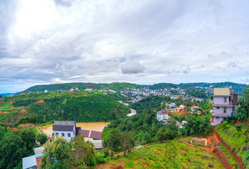 Small village in a tea hill valley on a stormy day in the highlands of Da Lat, Vietnam. The place provides a great deal of tea for the whole country