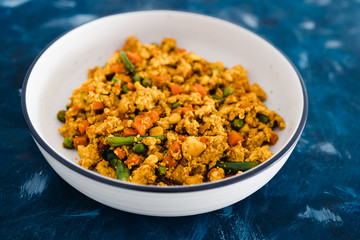 plant-based food, vegan tofu scramble with mixed vegetables including carrots green beans and peas