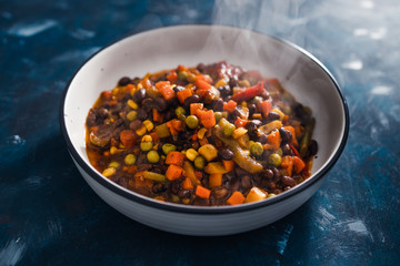 plant-based food, vegan lentils and beans stew with roasted vegetables