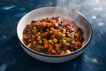 Fototapeta premium plant-based food, vegan lentils and beans stew with roasted vegetables