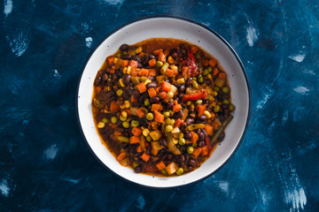 plant-based food, vegan lentils and beans stew with roasted vegetables